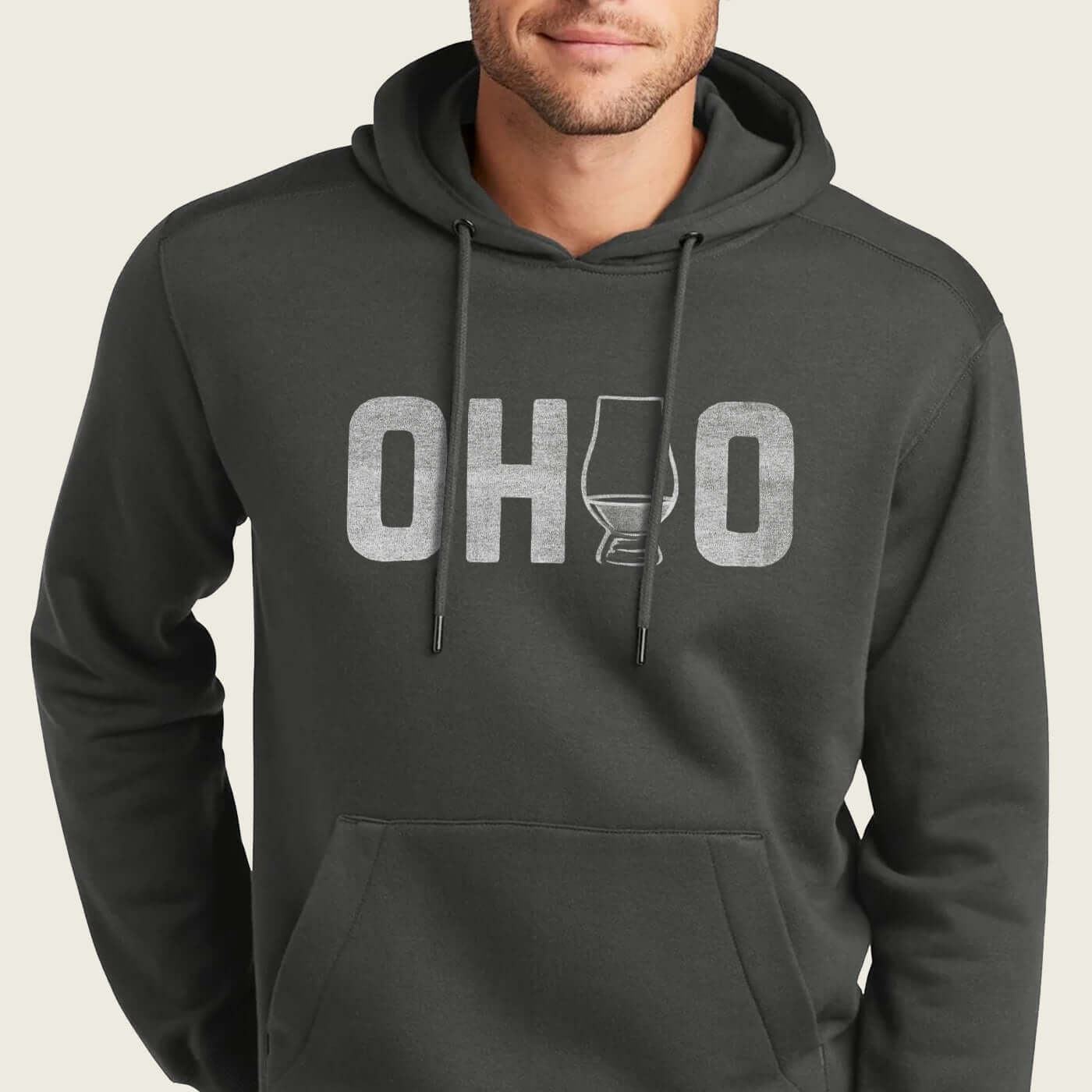 model wearing a charcoal grey hoodie with ohio whiskey design