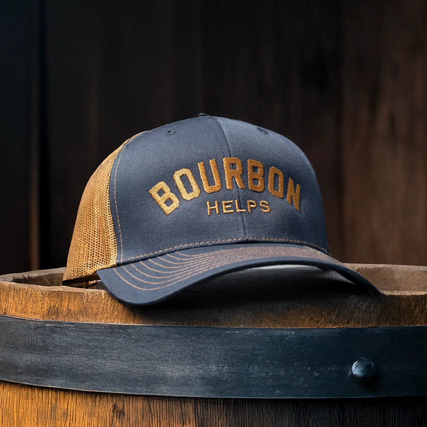 bourbon helps richardson 112 snapback hat sitting on a bourbon barrel in a dark room