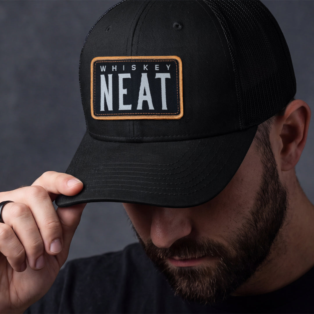 NEAT Whiskey Hat - Black with a woven patch featuring 'Whiskey NEAT' on a Richardson 112 cap.