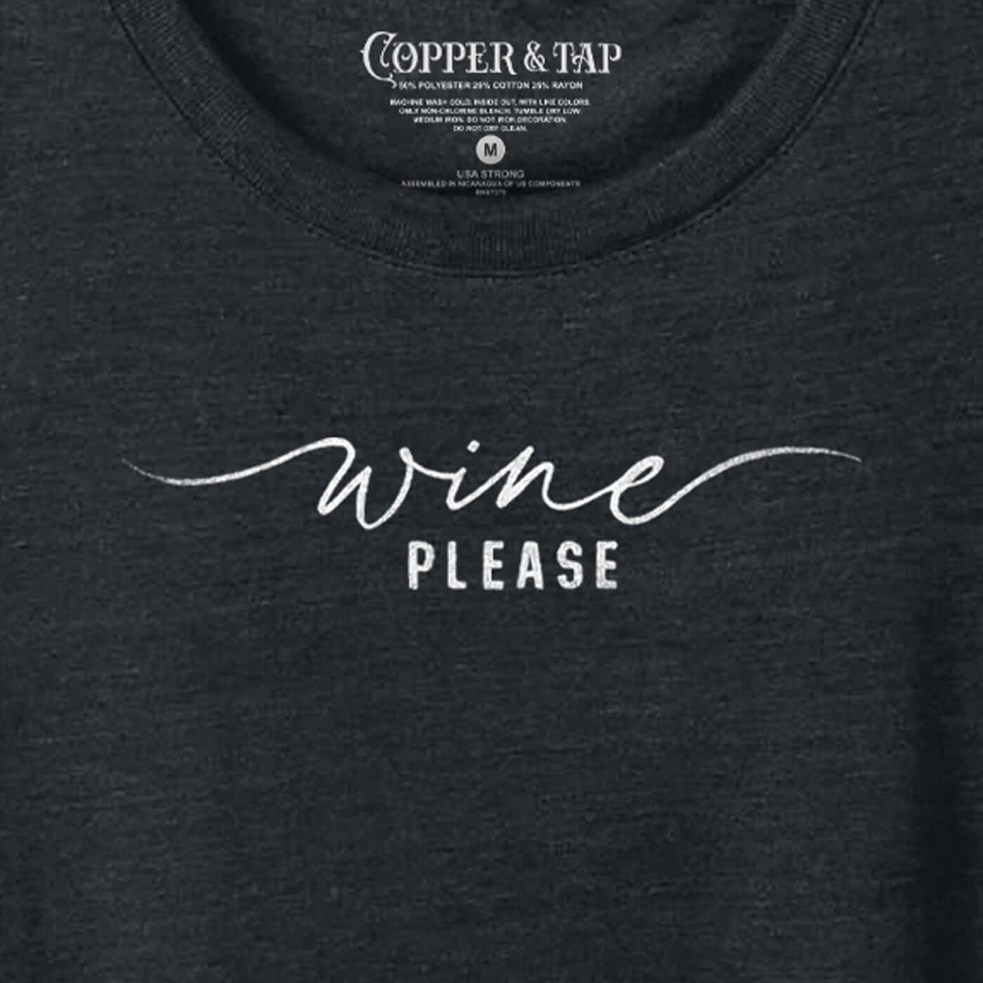 closeup of a black t-shirt with a graphic that reads "wine please"