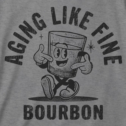 Gray t-shirt with black distressed graphic  "Aging Like Fine Bourbon" on a gray background