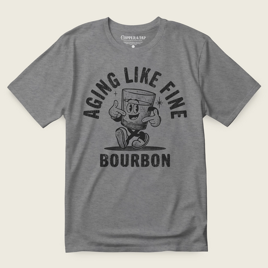 Gray t-shirt with 'Aging Like Fine Bourbon' graphic on a off white background
