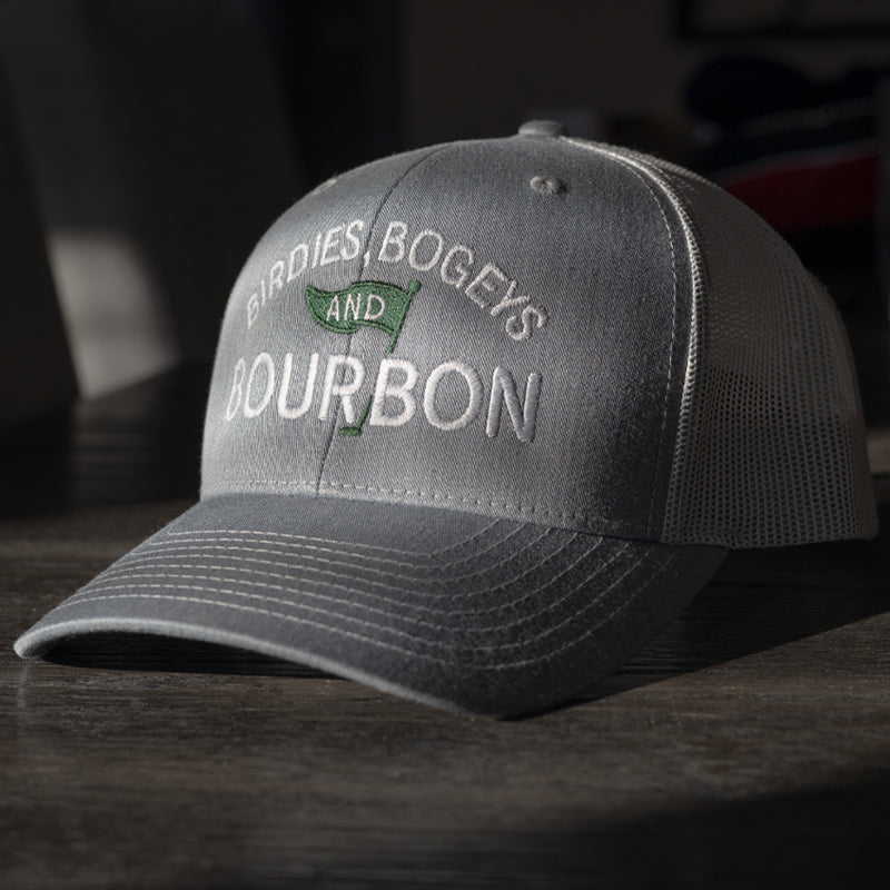 Gray Richardson 112 hat with 'Birdies, Bogeys and Bourbon' text on a dark surface