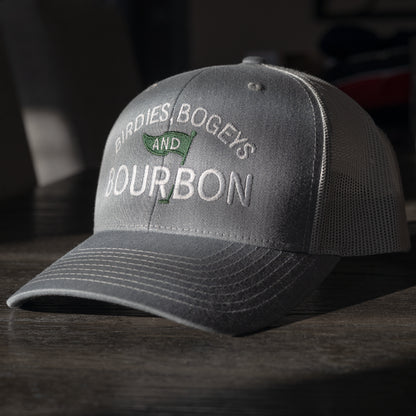 Gray Richardson 112 hat with 'Birdies, Bogeys and Bourbon' text on a dark surface