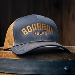 Navy Blue and brown cap with 'Bourbon Helps' text on a wooden barrel
