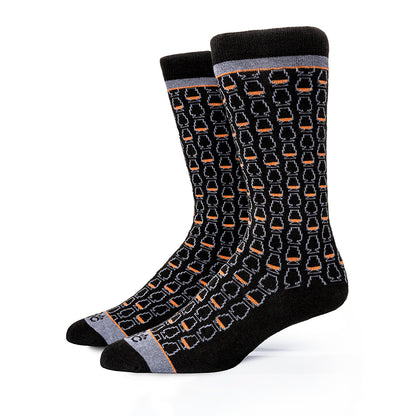 Pair of black bourbon socks with a whiskey glass pattern on a white background