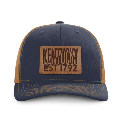 Kentucky 1792 Whiskey hat in navy blue and caramel with a genuine leather patch featuring 'Kentucky EST 1792'.