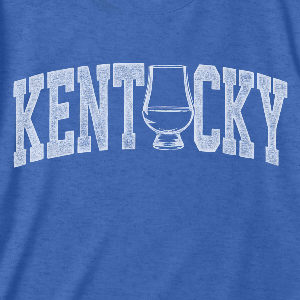 Kentucky whiskey tee featuring distressed graphic of whiskey glass on blue fabric, perfect for showing state pride.
