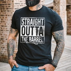 Person wearing a black t-shirt with 'Straight Outta The Barrel' text, standing against a brick wall.