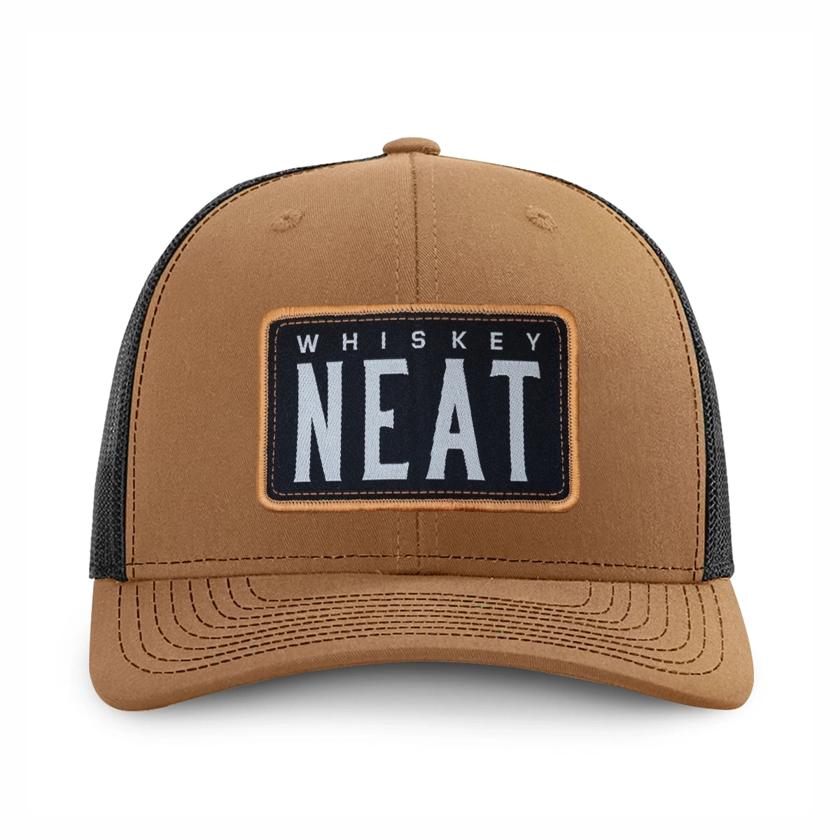 A caramel and black richardson 112 trucker hat with a rectangular front patch reading 'WHISKEY NEAT' in white text on a black background, shown on a clean white background.