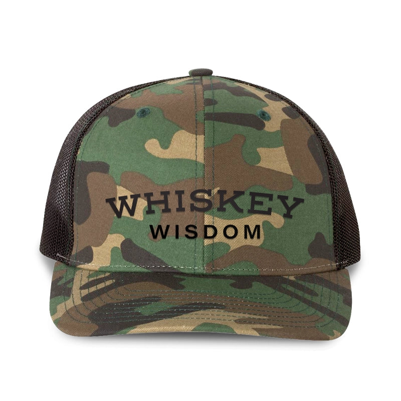 Whiskey Wisdom hat in camo and black, featuring bold lettering and a rugged design for bourbon lovers.