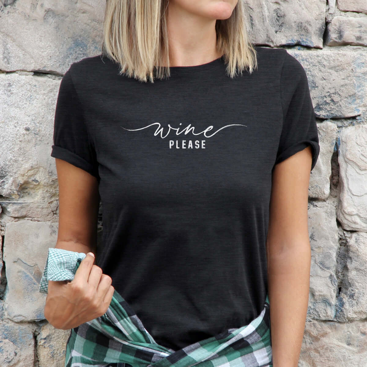 model wearing a black t-shirt with a graphic that reads "wine please"